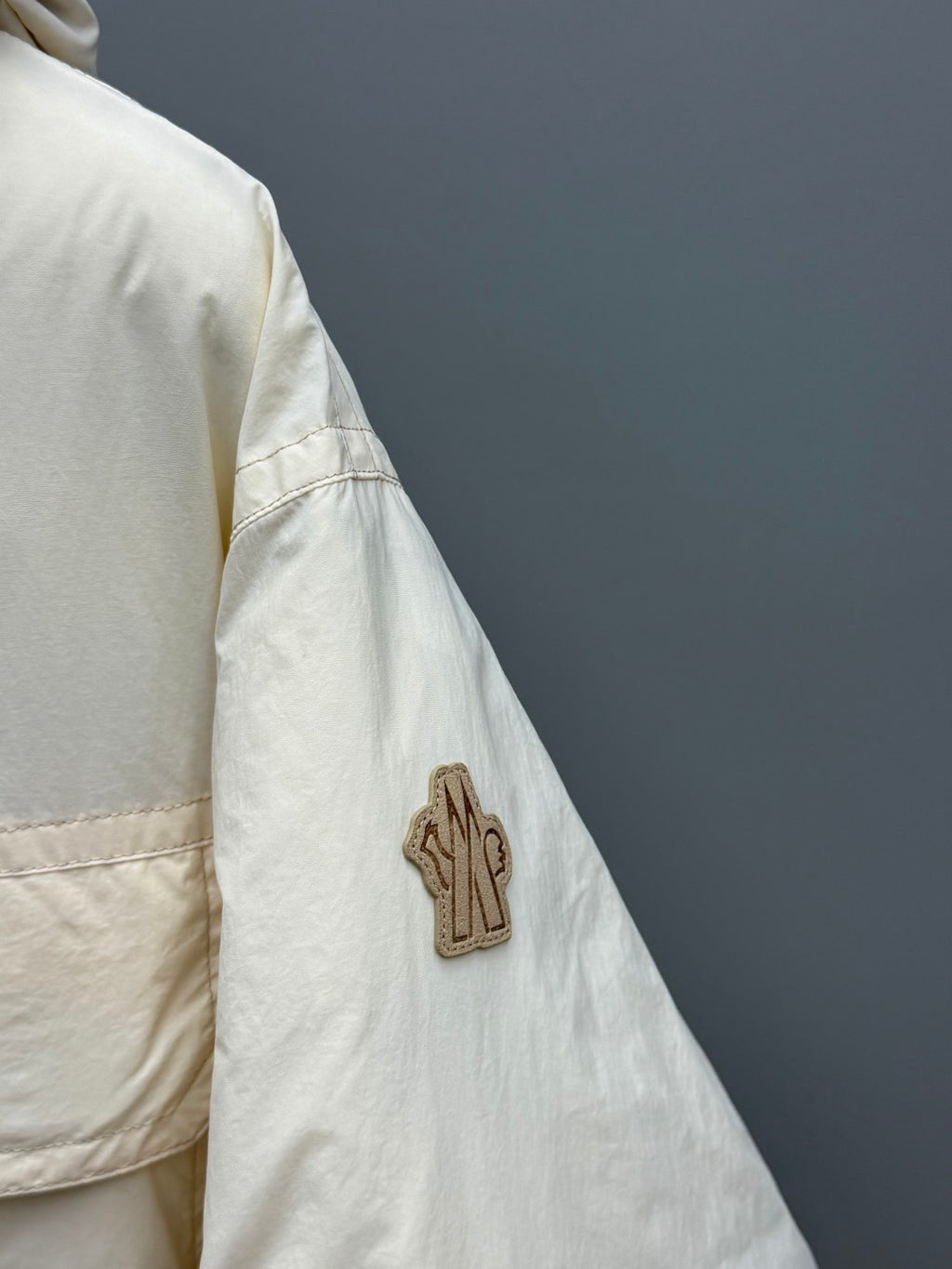 Light beige jacket sleeve with cactus appliqué patch