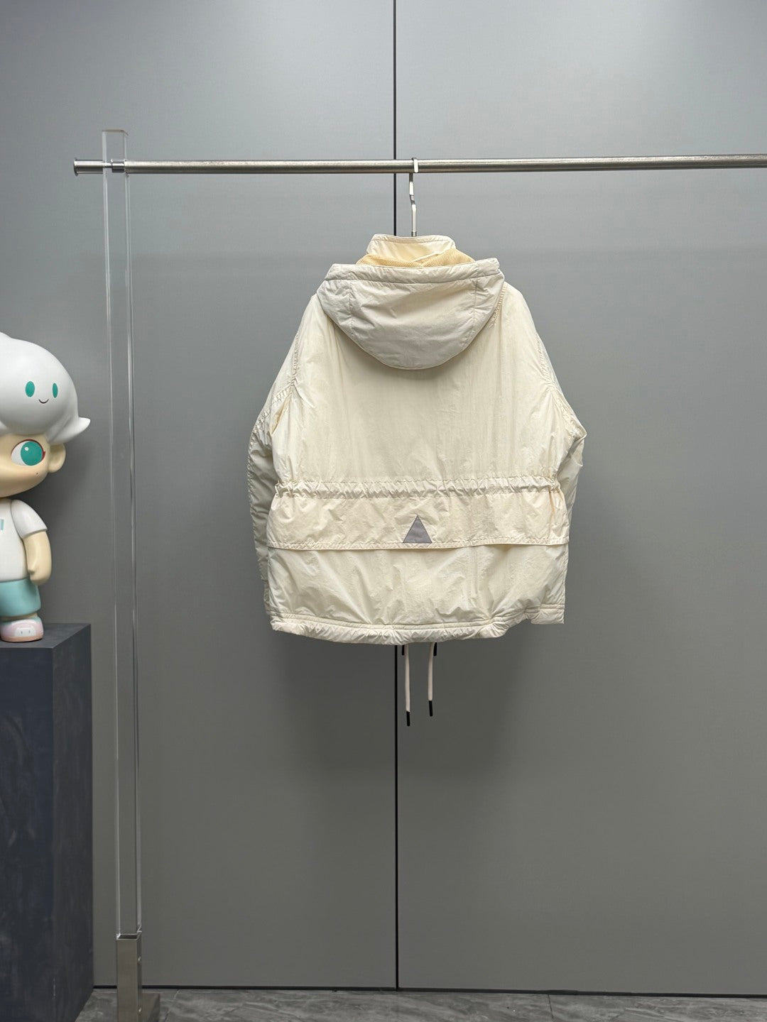Light beige Moncler puffer jacket with hood and back hemline quilting