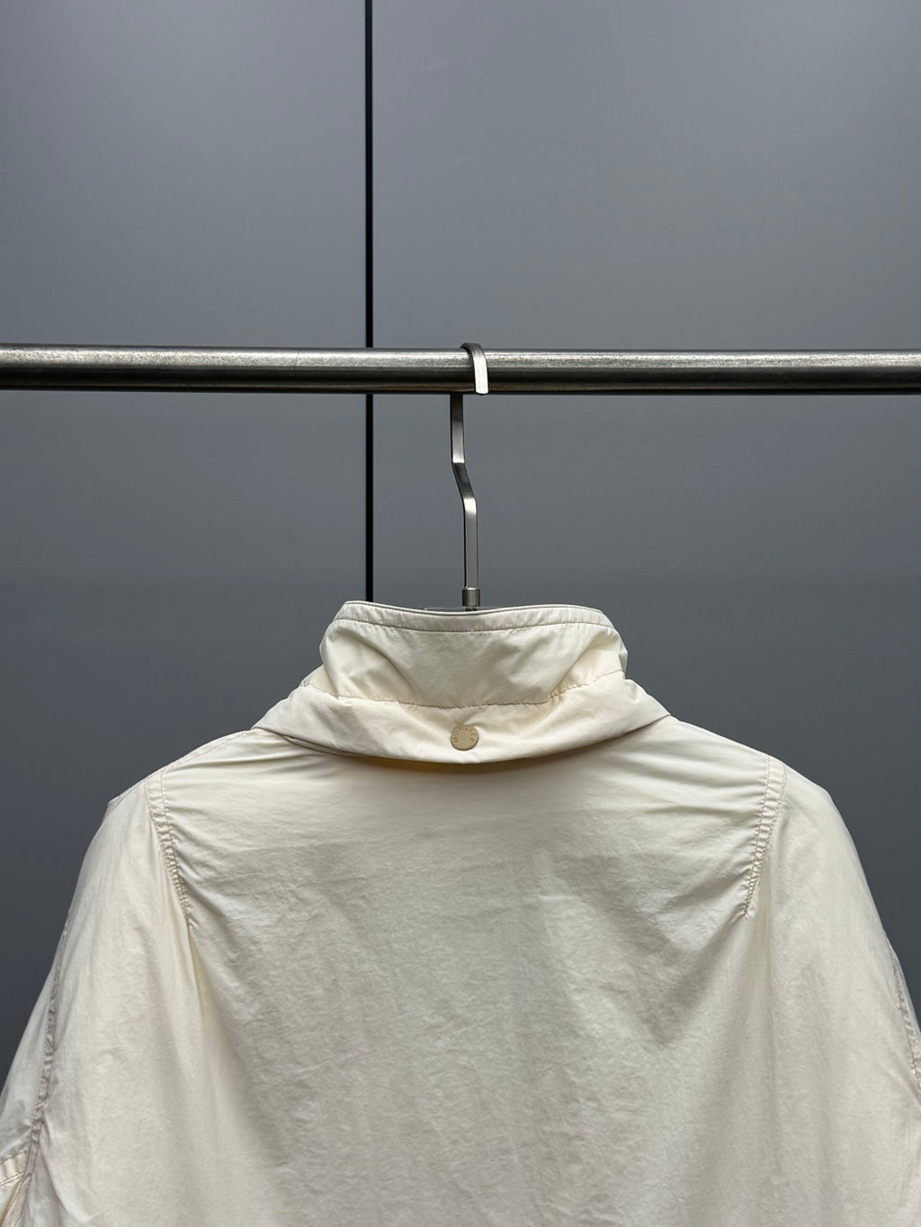 Cream long puffer jacket with high collar and zip front