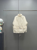 Long cream puffer jacket with hood, zip closure, and drawcord hem