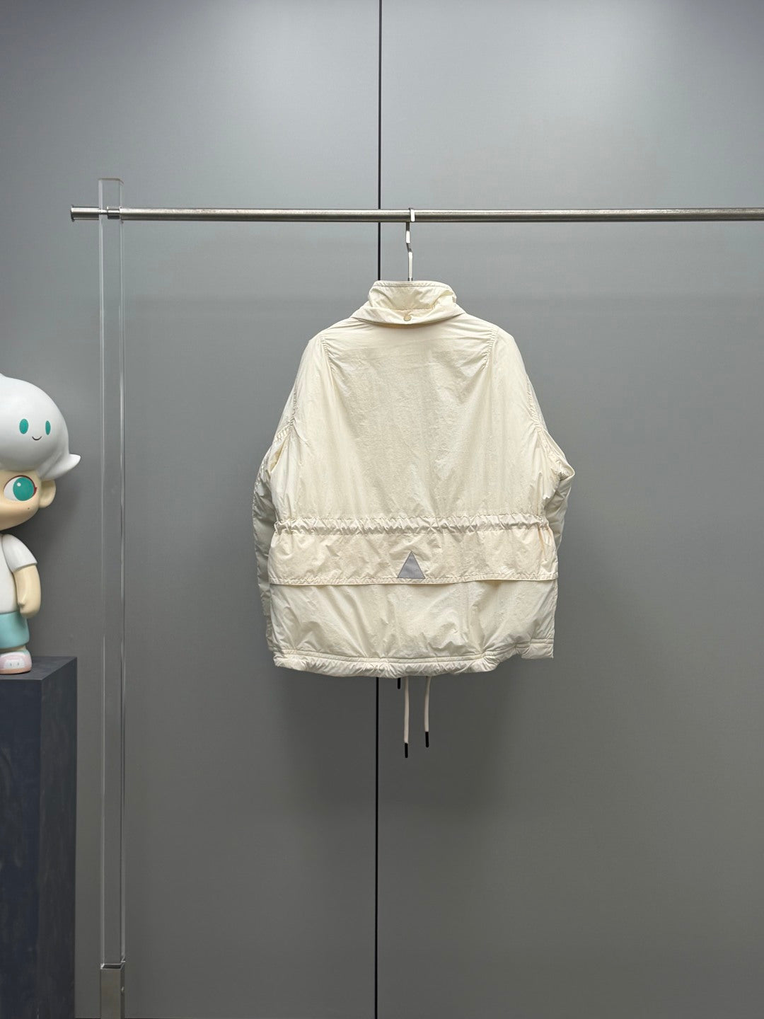 Long cream puffer jacket with hood, zip closure, and drawcord hem