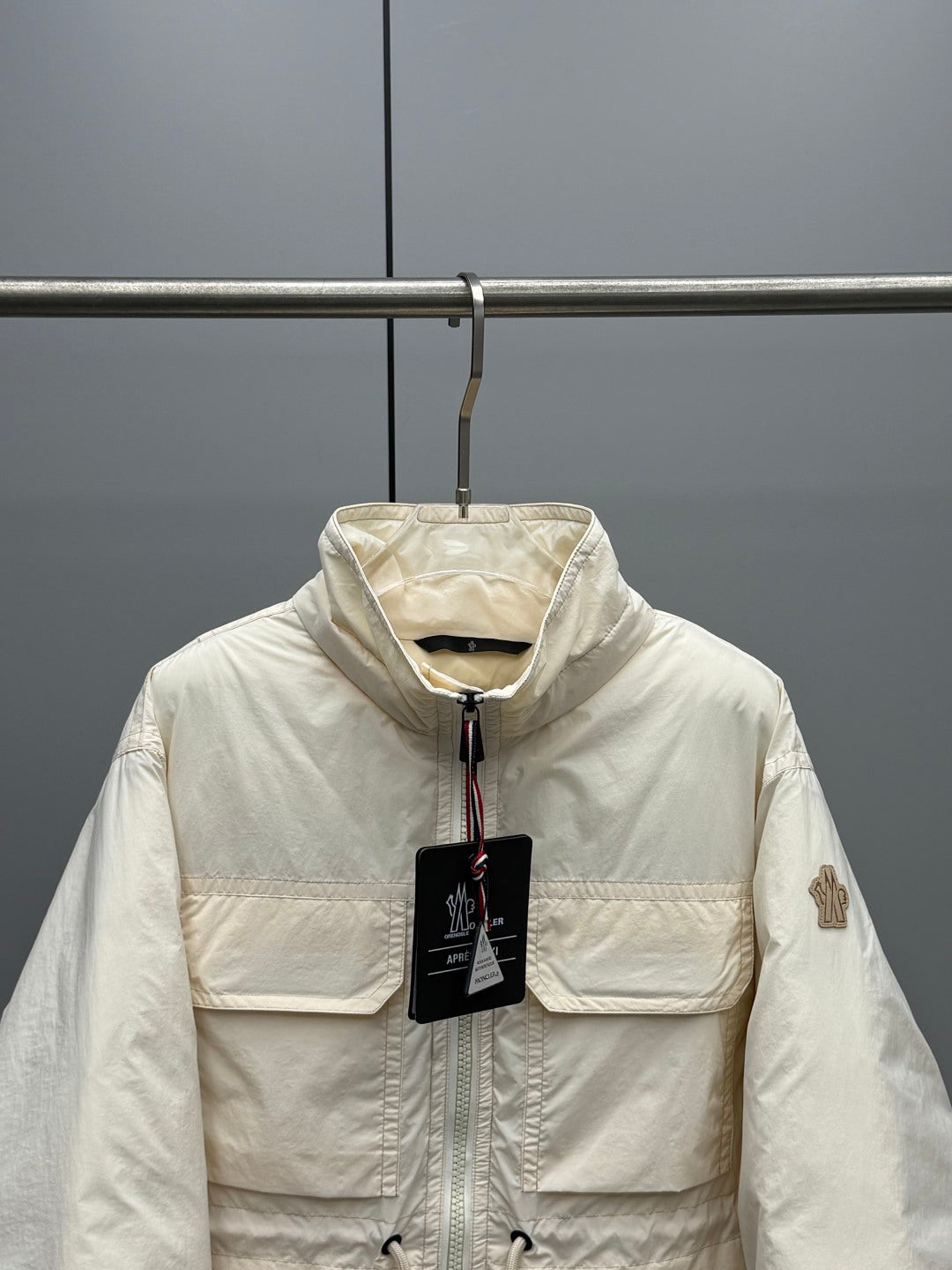 Long puffer jacket in cream with full zip, hood, and side pockets
