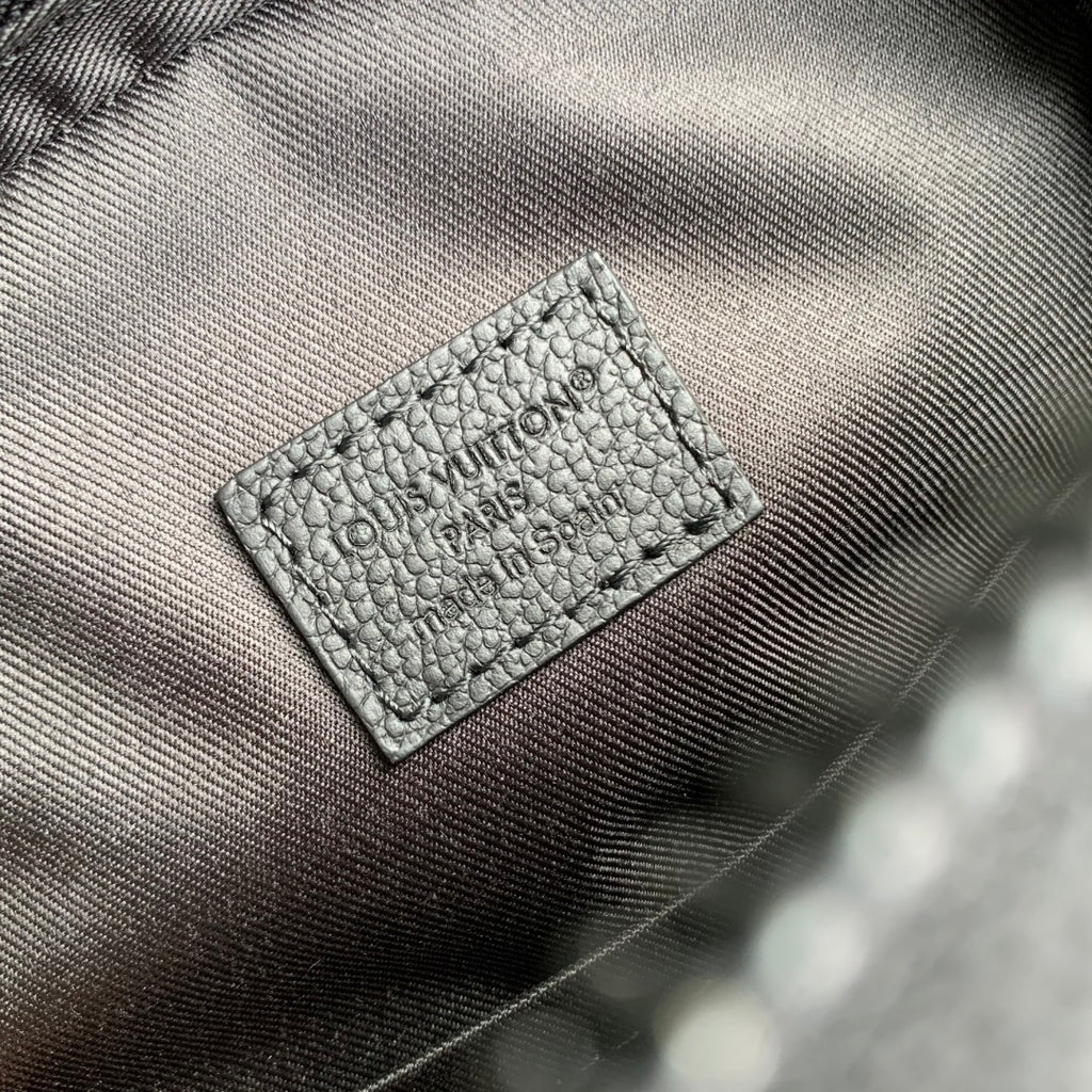 Embossed logo patch on gray leather lining with textured grain