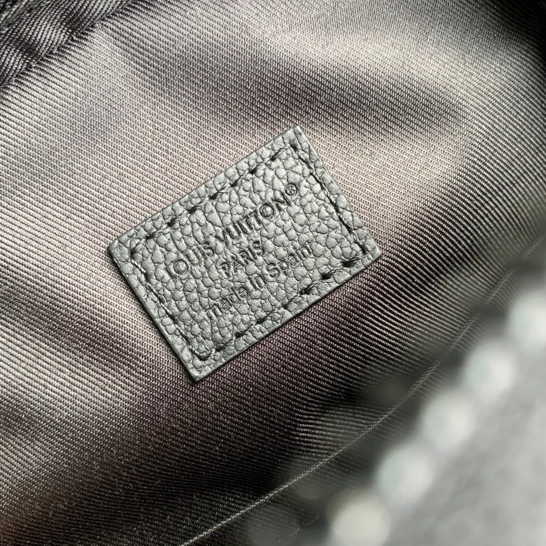 Embossed logo patch on gray leather lining with textured grain