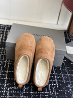 Balenciaga tan suede mules with shearling lining, back view of pair