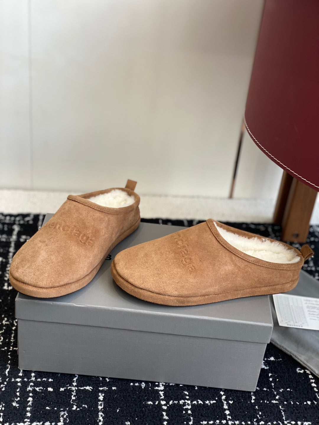 Balenciaga tan suede shearling-lined mules, pair shown from side angle