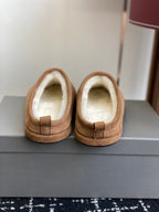Balenciaga tan suede slip-on mules with shearling lining, top view of pair