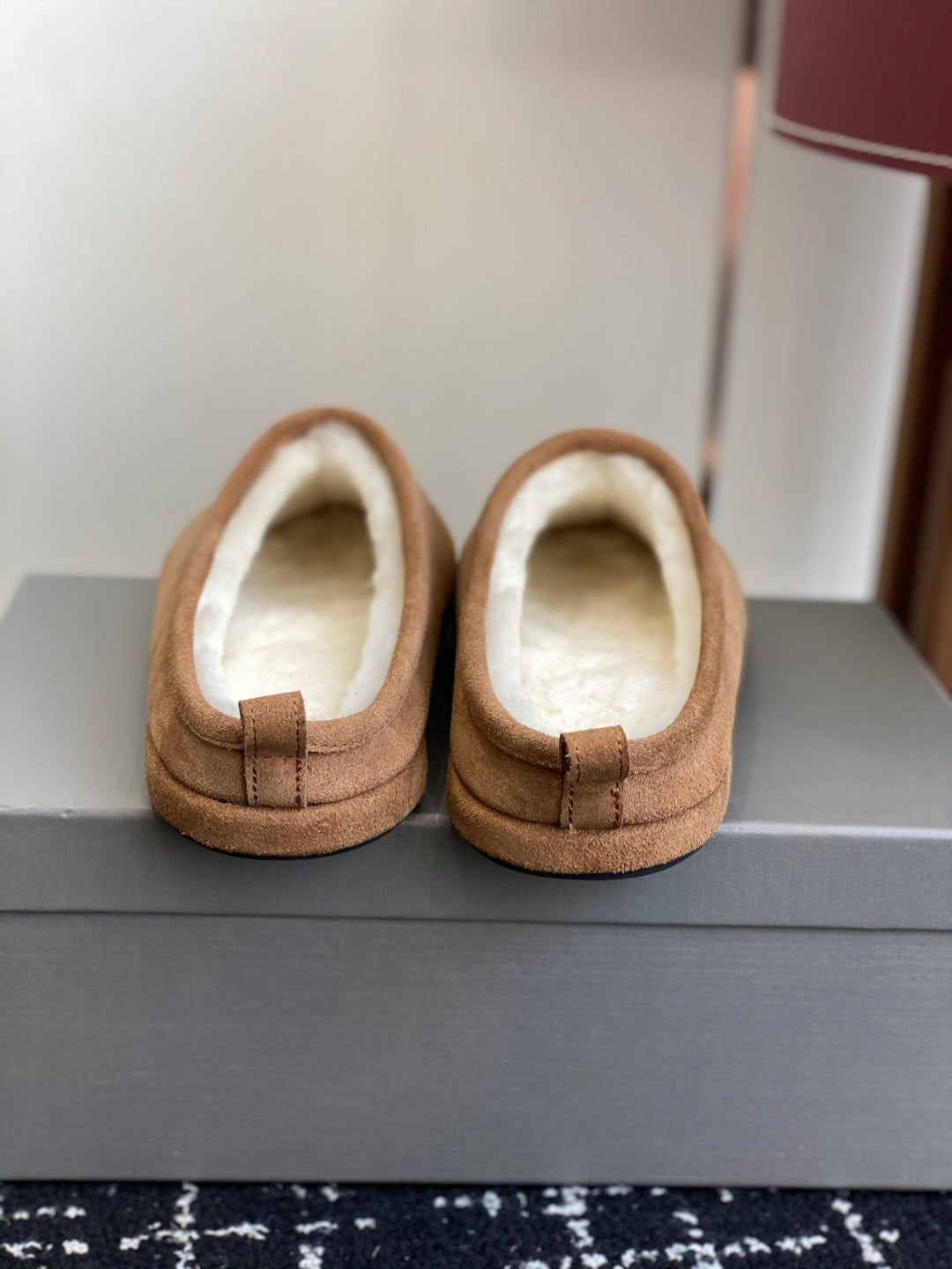 Balenciaga tan suede slip-on mules with shearling lining, top view of pair
