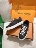 Louis Vuitton low-top sneakers, black with monogram texture, white midsole and lace charms