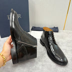 Black leather ankle boots with lace-up front, side zipper, wingtip toe, low heel