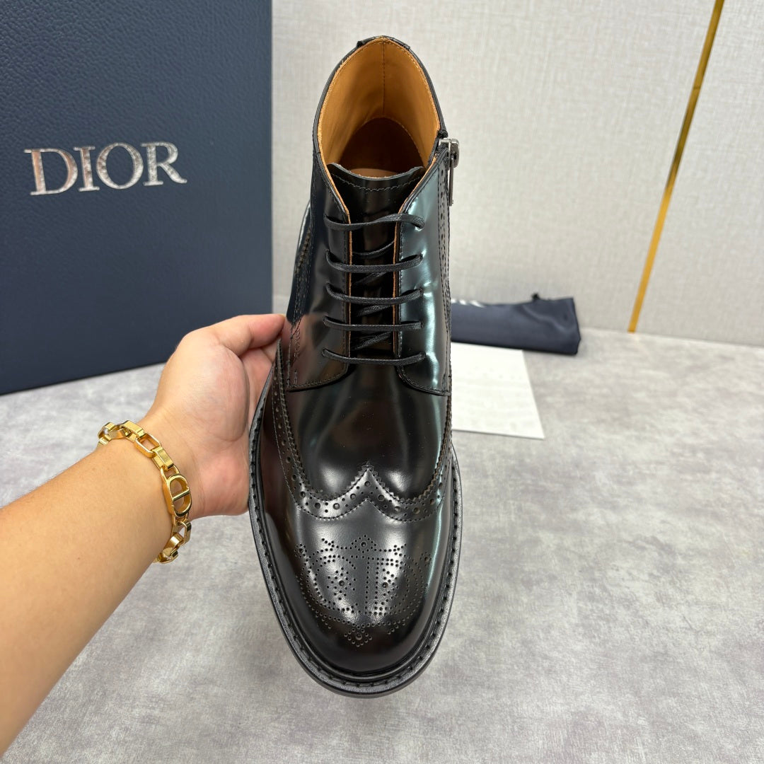 Black leather lace-up boot with brogue toe and polished finish, ankle-height
