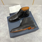 Dior unisex black leather lace-up boots with brogue detailing and chunky sole with orange edge