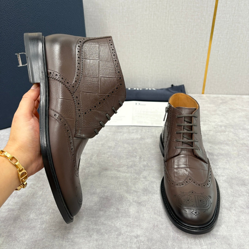 Brown leather ankle boots with embossed texture, lace-up front, and black rubber soles