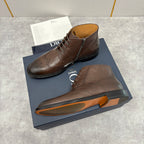 Brown leather ankle boots with side zip, brogue perforations, and black sole.