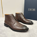 Brown leather lace-up ankle boots with brogue perforations and black rubber sole