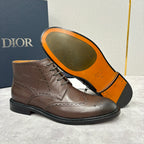 Brown leather lace-up ankle boot with brogue perforations and orange-lined interior
