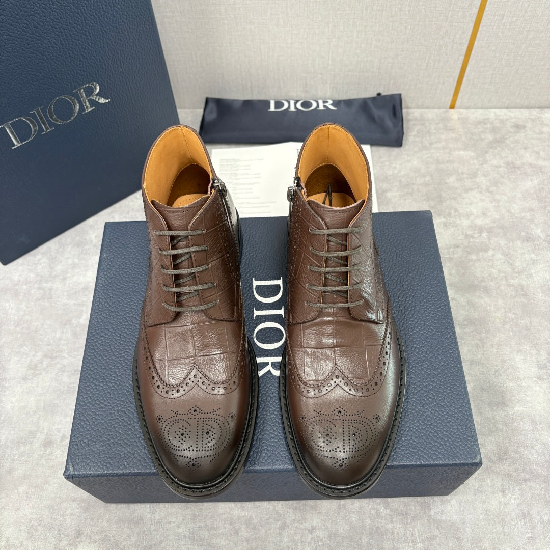 Pair of brown leather lace-up ankle boots with brogue pattern and warm tan lining