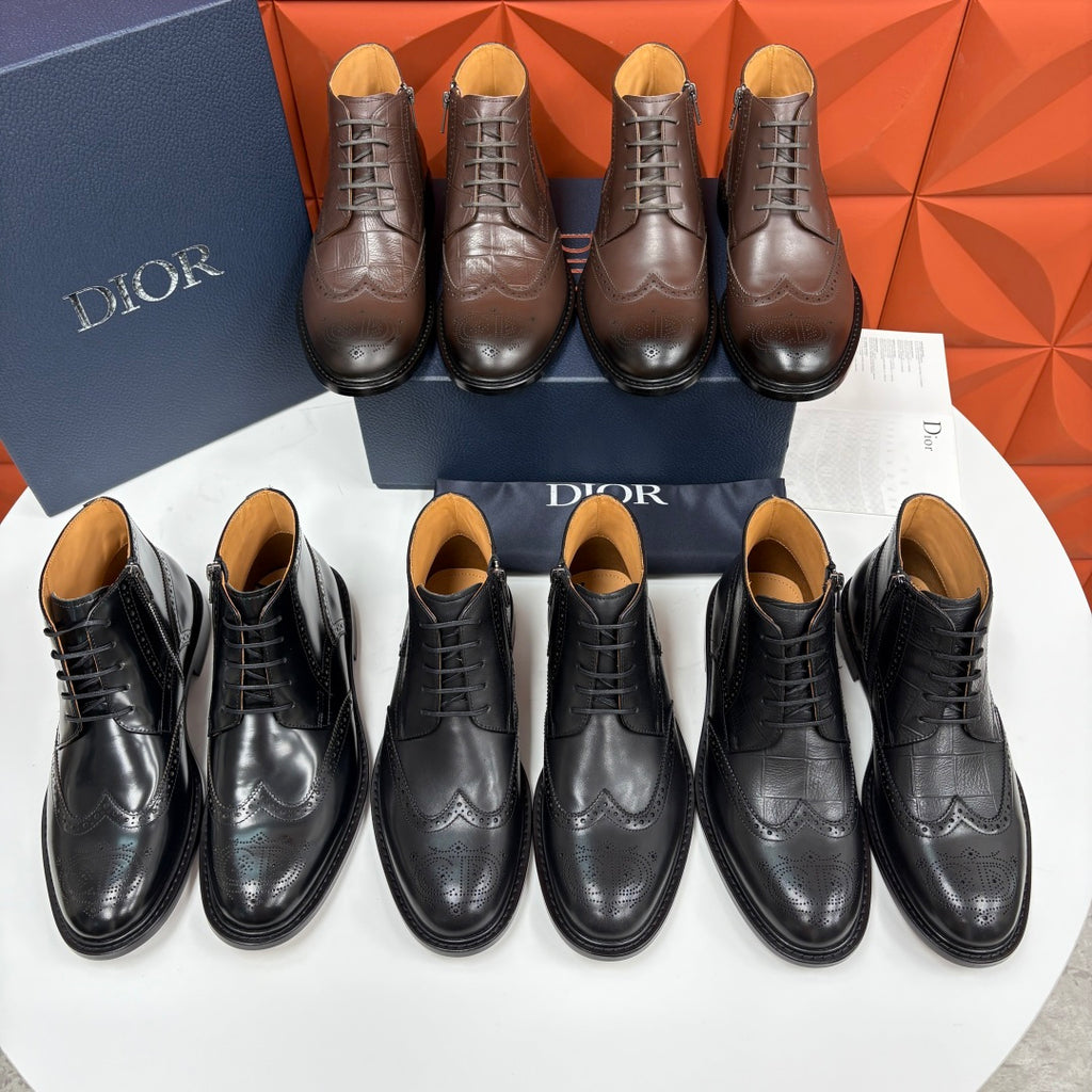 Set of black leather lace-up ankle boots on display with orange-brown insoles