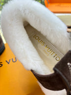 Louis Vuitton insole text on white faux-fur lining inside brown suede slipper