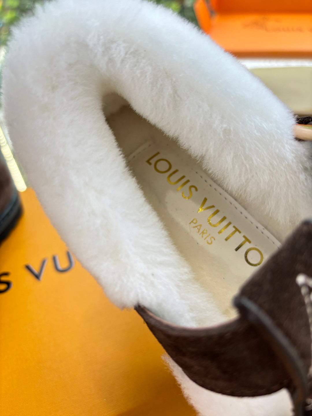 Louis Vuitton insole text on white faux-fur lining inside brown suede slipper