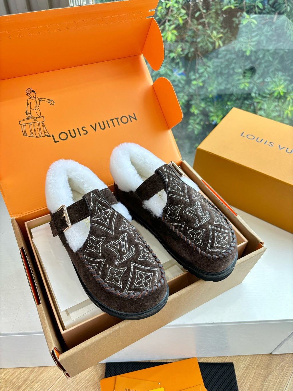 Louis Vuitton suede loafers with dark monogram pattern, white faux-fur lining