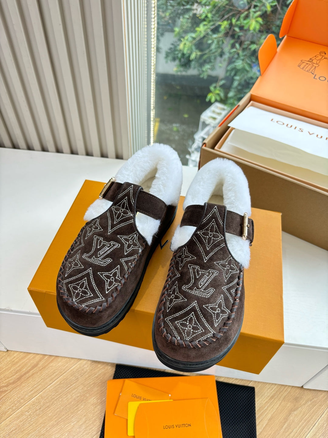 Louis Vuitton suede loafers with monogram pattern and white faux-fur collar, buckle