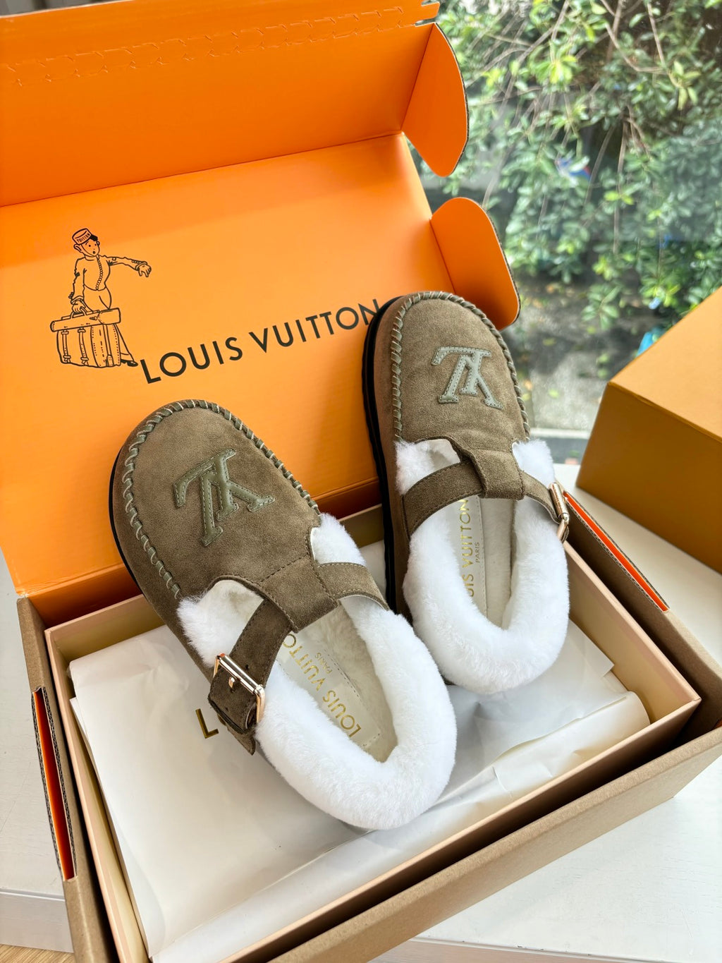 Taupe suede moccasin slip-on with white shearling and LV emblem on side