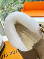 Inside view of taupe shearling-lined moccasin with Louis Vuitton logo-printed insole