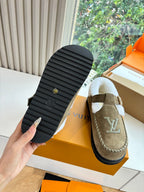 Bottom view of taupe suede moccasin shoes with black rubber tread sole