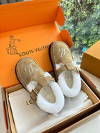 Tan suede shearling moccasin loafers with buckle strap and Louis Vuitton monogram.