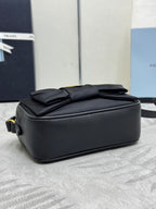 Prada crossbody bag backside view, black with stitched folds and top edge