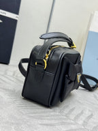 Prada small crossbody bag, black with top handle and adjustable shoulder strap
