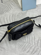 Prada mini crossbody bag with front pouch detail, black leather and gold zipper