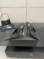 YSL black slingback pumps with pointed toe and gold logo detail, angled view
