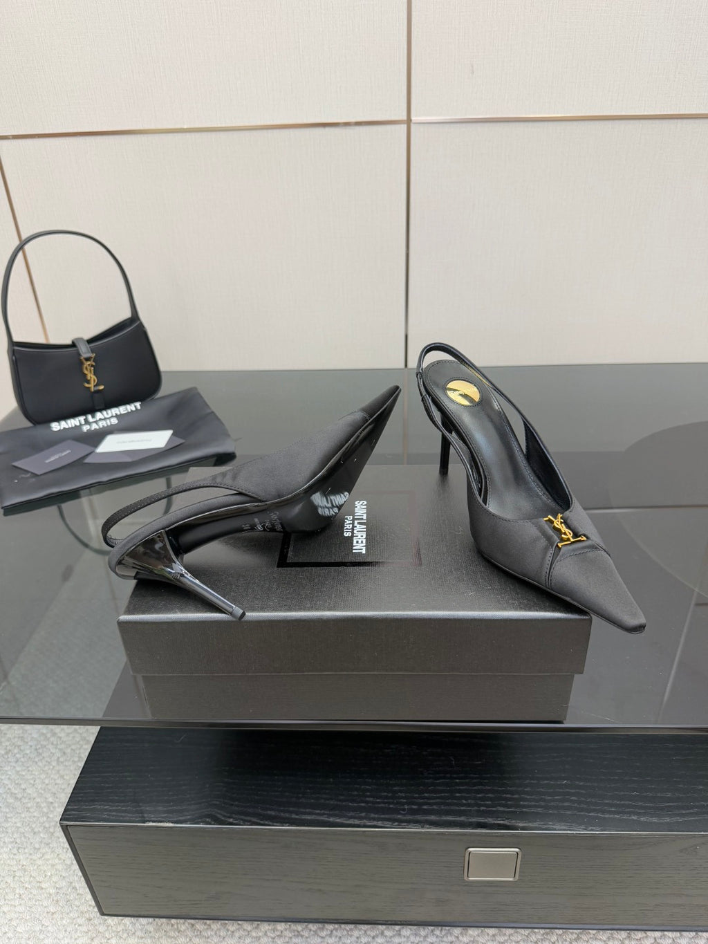 YSL black slingback pumps with stiletto heel, side view with strap detail