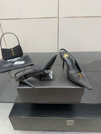 YSL black slingback pumps with stiletto heel, side view with strap detail