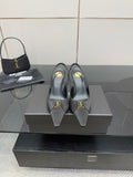 YSL black leather-look heeled pumps with gold logo detail, on display