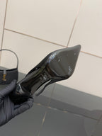 YSL black slingback pump close-up, underside with logo detail