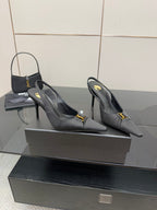 YSL black slingback pumps with gold logo detail, rear angle