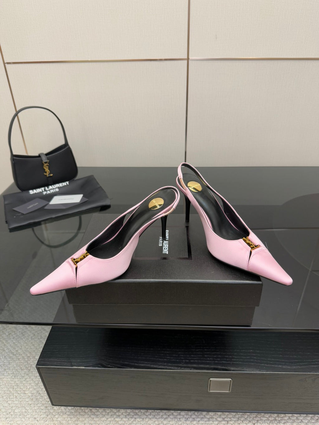 Pink pointed-toe slingback heels with gold buckle on ankle strap