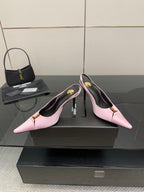 Pink pointed-toe slingback heels with gold buckle on ankle strap