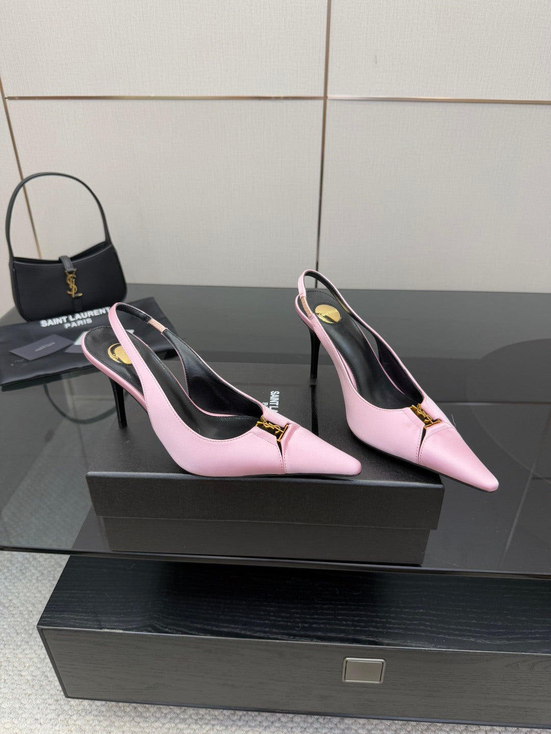 Pair of pink leather pointed-toe slingback heels with gold buckle detail