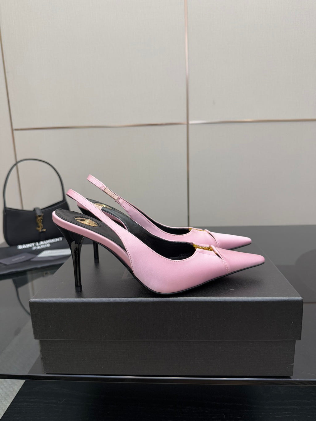 Pink leather slingback pumps with black lining and high stiletto heel