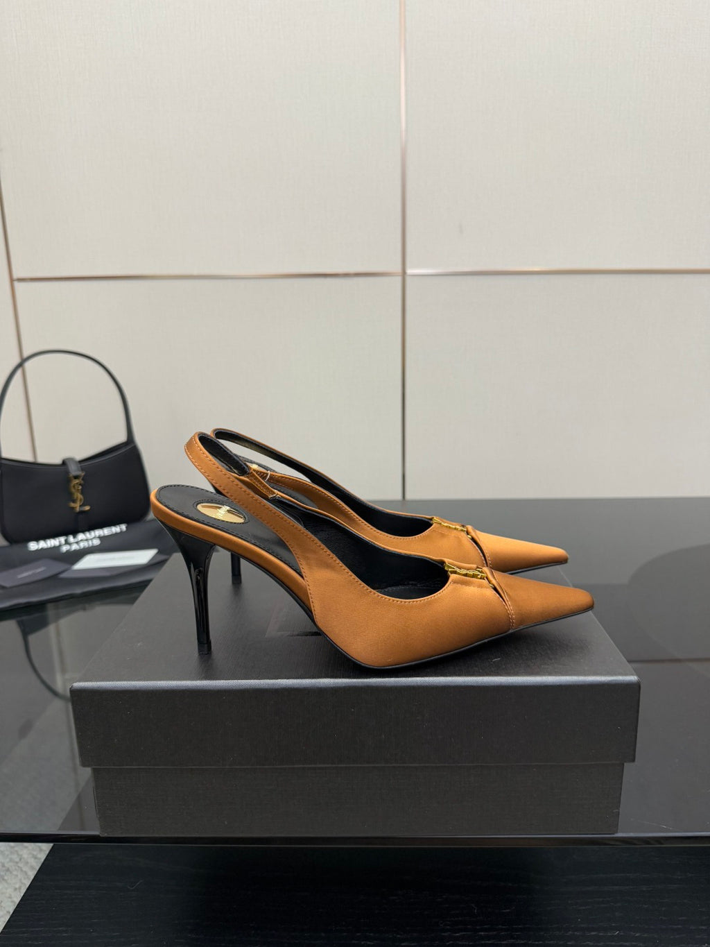 Tan orange pointed-toe slingback stiletto heels with gold logo detail