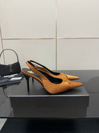 Tan orange pointed-toe slingback stiletto heels with gold logo detail