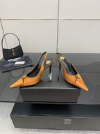 Orange pointed-toe slingback high heels with slim heel and gold hardware