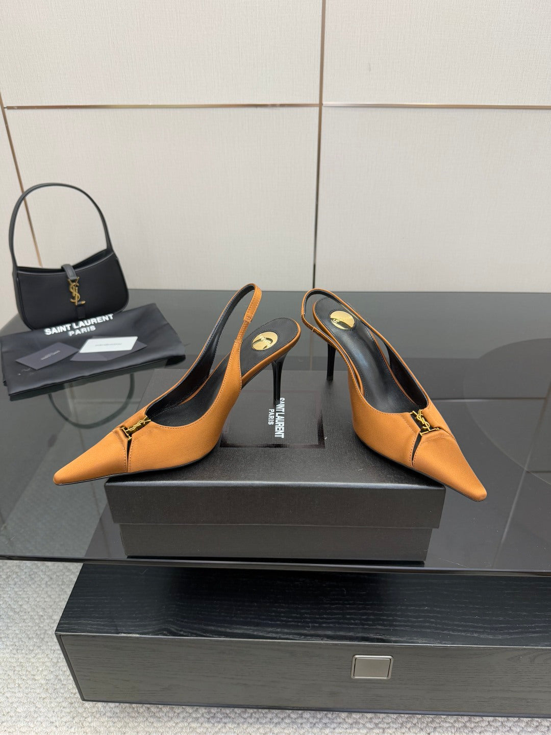 Orange pointed-toe slingback high heels with slim heel and gold hardware