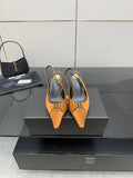 Orange pointed-toe slingback heels with black insole and gold logo accent