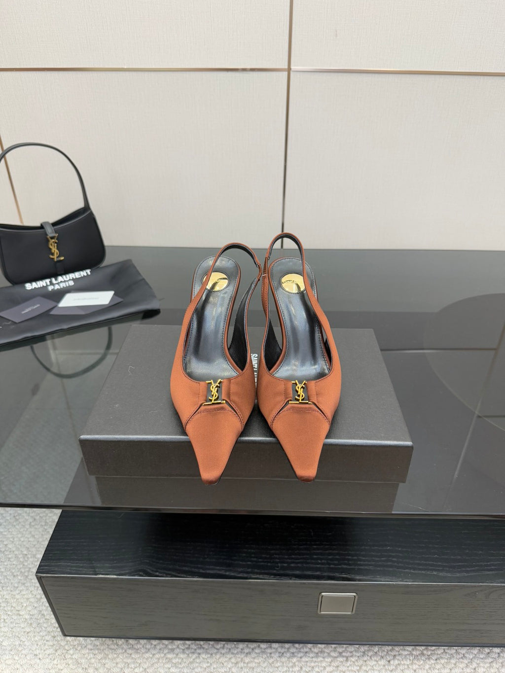 Tan leather slingback heels with pointed toe, thin stiletto heel, gold logo detail
