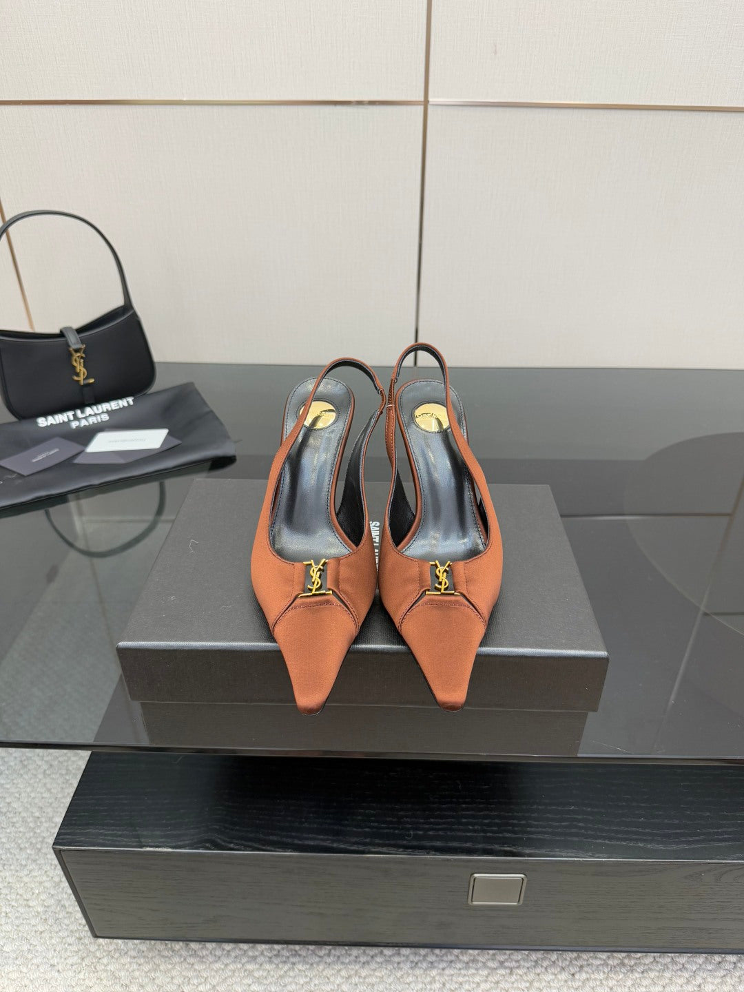 Tan leather slingback heels with pointed toe, thin stiletto heel, gold logo detail
